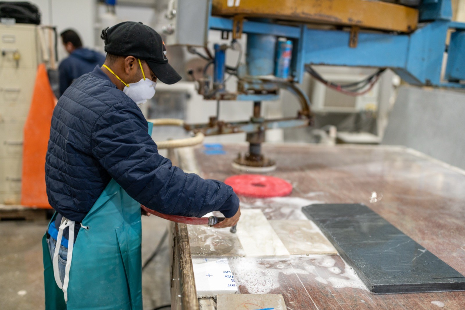 Fox fabricator working at a saw in the shop.