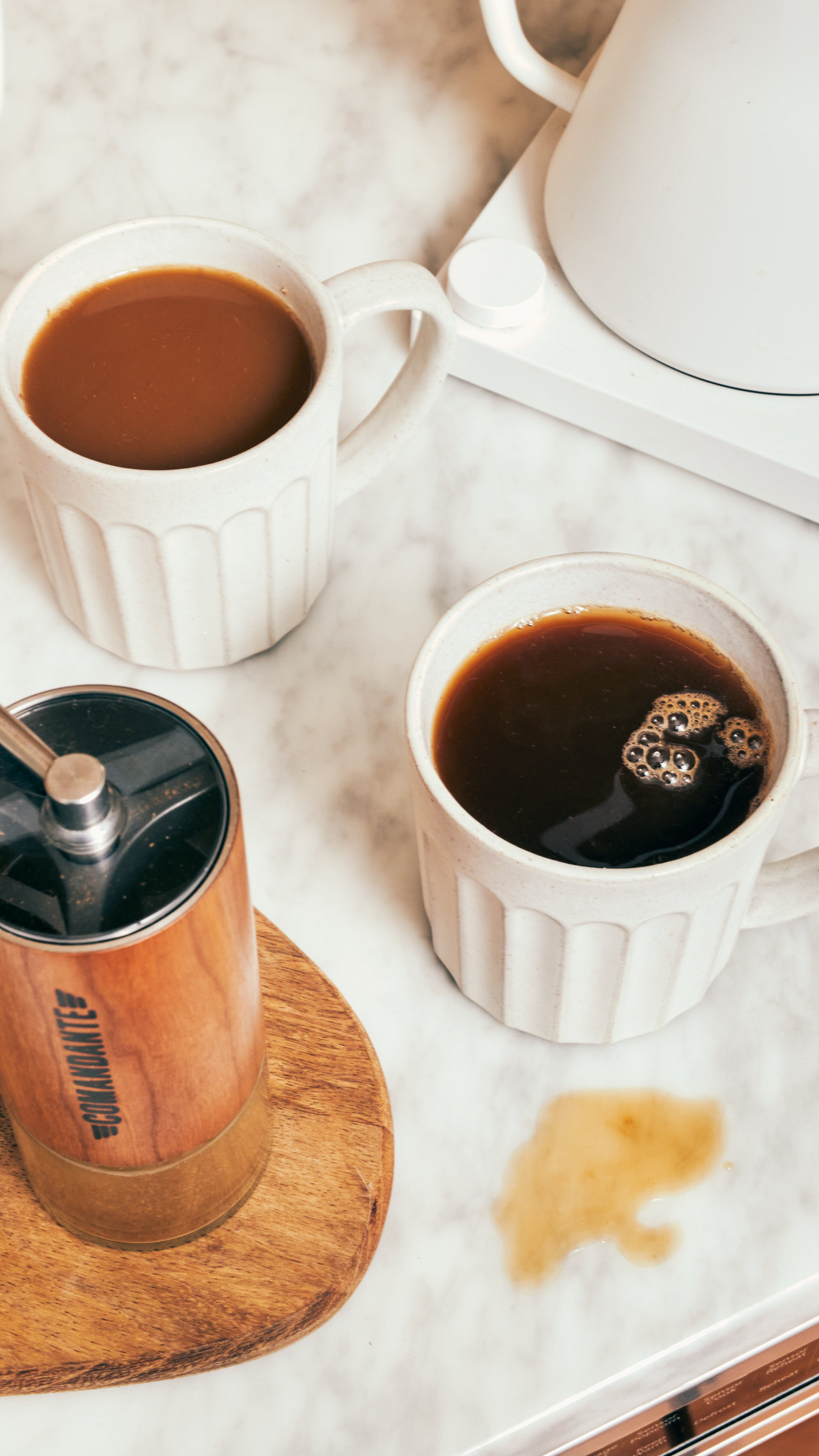 Coffee and a kitchen appliance on a light marble counter